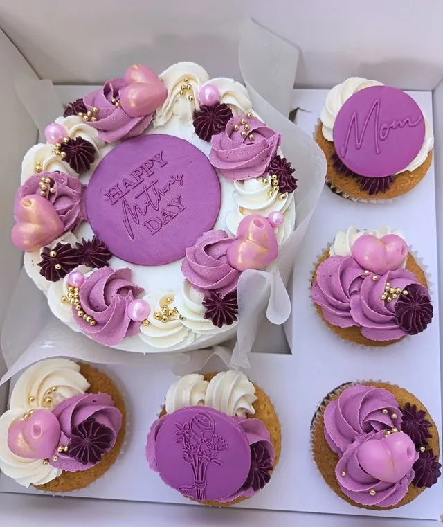 Boxed Mother’s Day cake with purple buttercream swirls and matching cupcakes